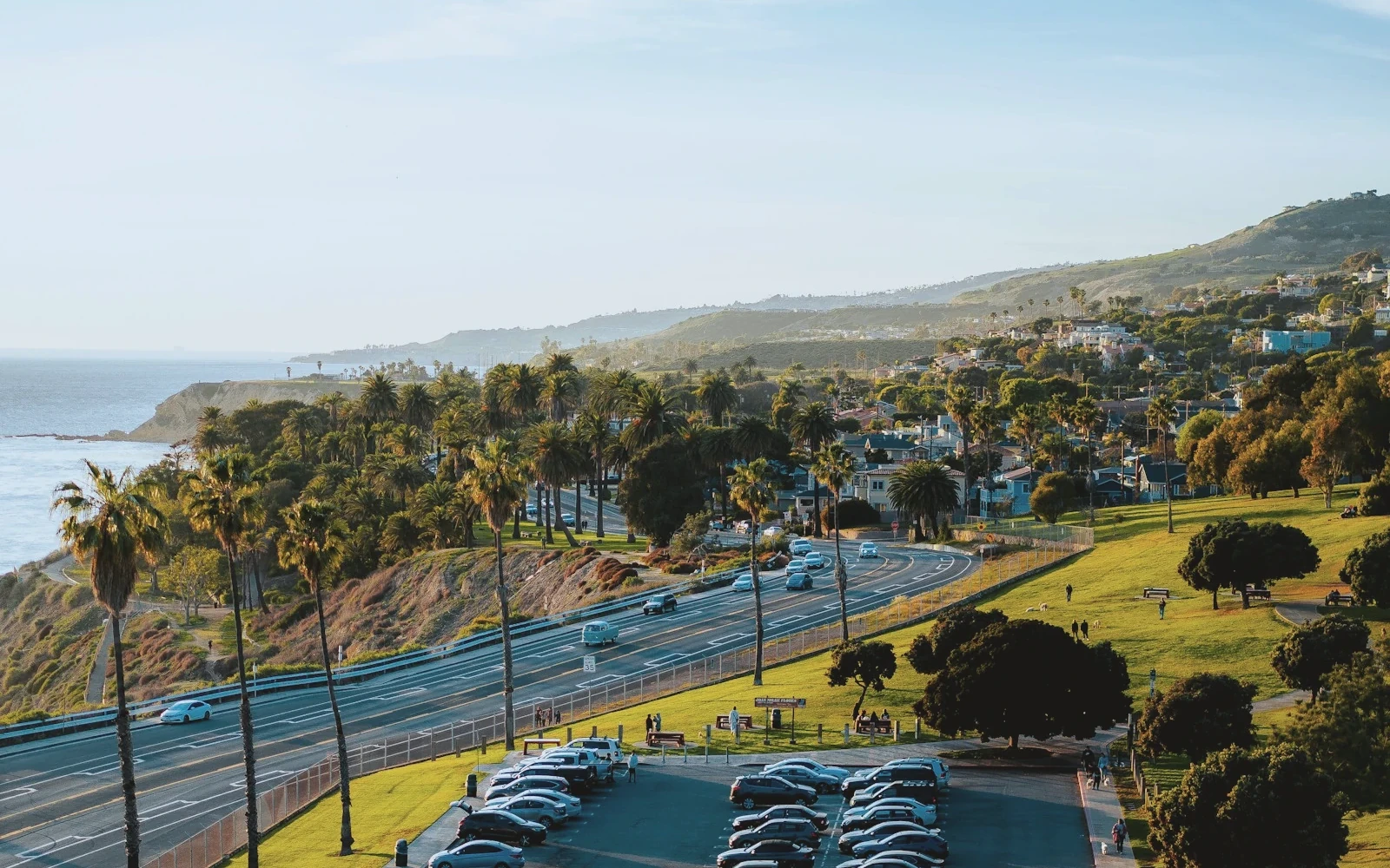 Aerial view of a palm-lined San Diego freeway at dusk